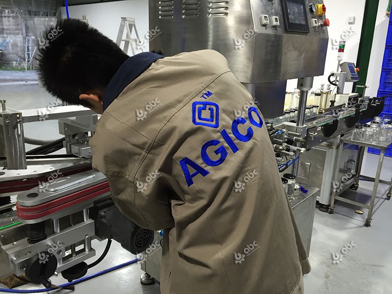 workers installing coconut oil filling equipment
